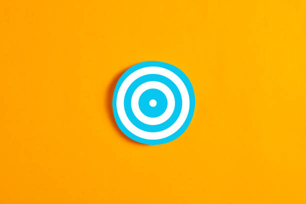 Blue round circle with a target icon against yellow background. Goal, aspiration, strategy or target group in business concept.