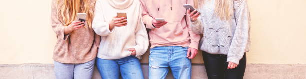 istock New normal during lockdown - Multiracial group of friends playing on mobiles - Students addicted to technology playing on phone - Technology and urban concept - Millenial best friends using mobiles - Group of friends using apps on their mobiles. Hipsters 1294901075