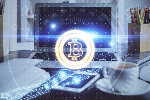 istock Multi exposure of blockchain and crypto economy theme hologram and table with computer background. Concept of bitcoin cryptocurrency. 1294905600