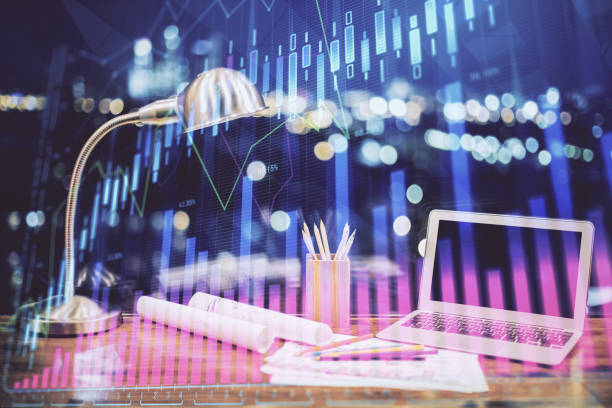 istock Stock market graph and table with computer background. Multi exposure. Concept of financial analysis. 1294905718