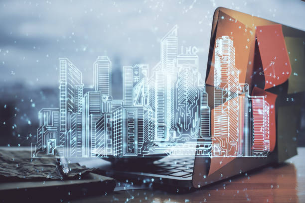 istock Desktop computer background in office and big town buildings hologram drawing. Double exposure. Smart city concept. 1294906167