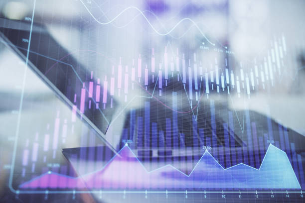 istock Forex graph hologram on table with computer background. Double exposure. Concept of financial markets. 1294907344