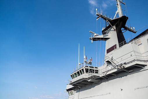 Navy frigate moored at naval dockyard.