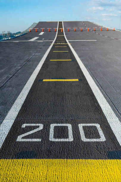 number 200 on flight deck of aircraft carrier. airplane runway on military navy ship. aviation concept - pista de aeroporto imagens e fotografias de stock