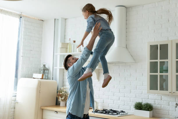 istock Loving father playing funny active game with adorable little daughter 1294912763
