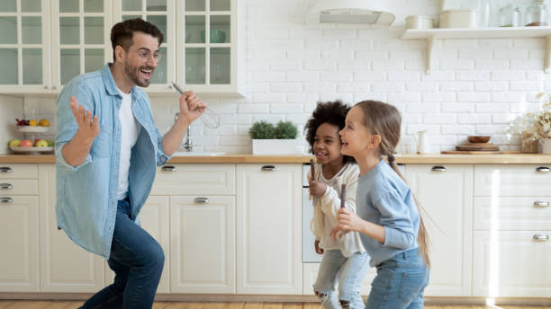 istock Overjoyed father with two diverse daughters having fun in kitchen 1294912769