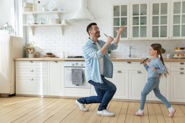 istock Happy young father with little daughter having fun with kitchenware 1294912780