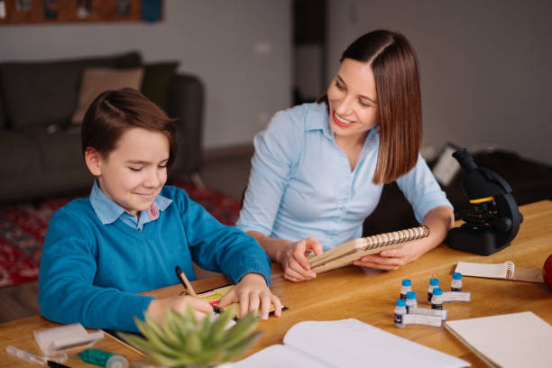 istock Home learning, woman and boy study at the table 1294914745