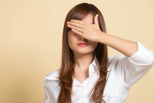 istock Young Asian woman close her eyes with hand. 1294914799