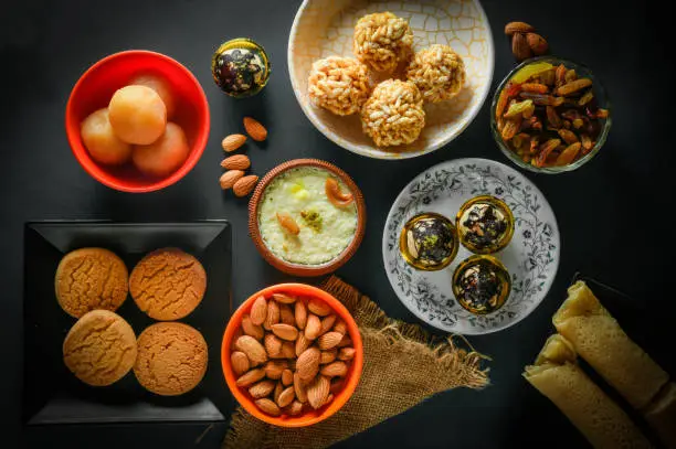 Photo of Home made tasty Diwali food snacks,sweets with dry fruits in white bowls, Favourite recipe of India.  lohri festival kheer