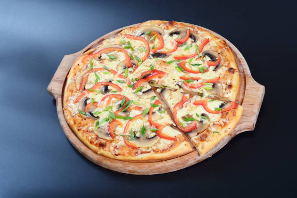 istock Delicious fresh pizza with different fillings lies on a dark background 1294916205