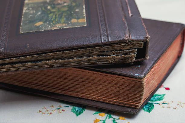istock Old photo album on a tablecloth with embroidery. 1294916967