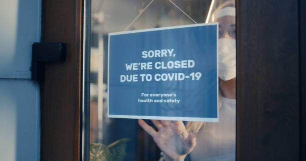 istock Upset woman closing cafe because of virus outbreak 1294917599