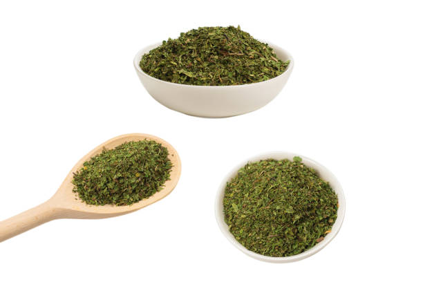 istock Dry mint in wooden spoon isolated on white. 1294918204