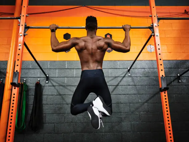 Photo of Man Working Out in a Gym Doing Pull-ups