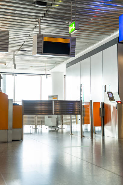 istock Orange empty airport check-in counter with scoreboard and light from window 1294922082