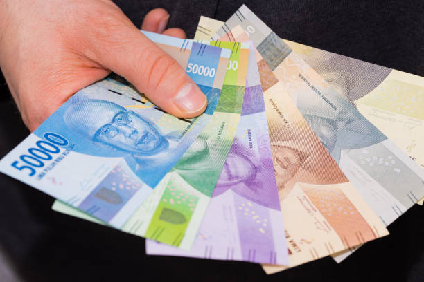istock Indonesian money in your hand, various banknotes 1294922836
