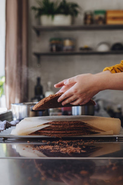 istock Anonymous Young Woman Preparing a Chocolate Cake Crust in a Kitchen at Home 1294924450