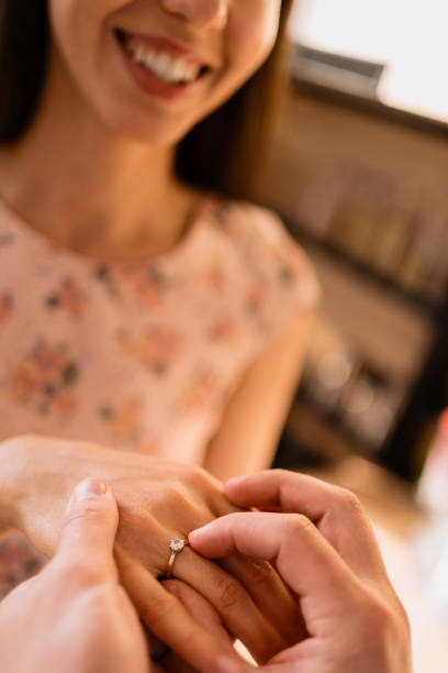 istock Man puts the ring on his girlfriends finger 1294924563