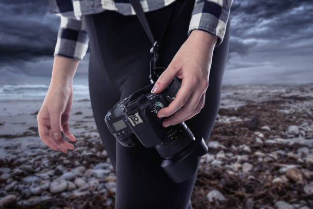 istock Photographer Holding a Camera On a Stormy Coastline 1294925869