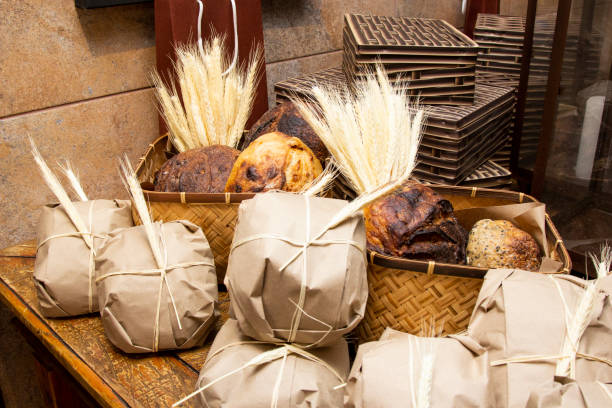 Homemade breads exposed on wooden table.