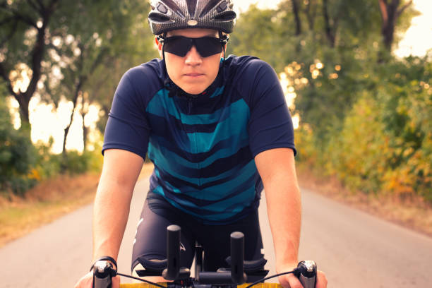 istock Young man cycling on the road 1294927968