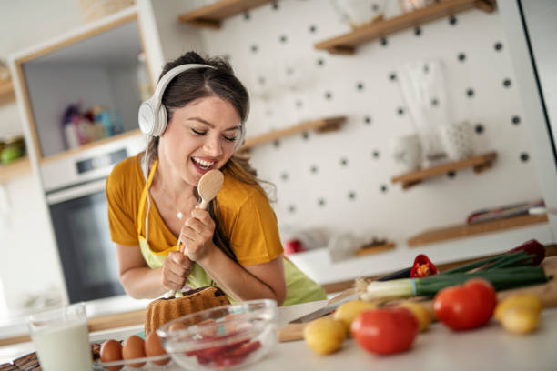 istock Young woman having fun in the kitchen 1294928265