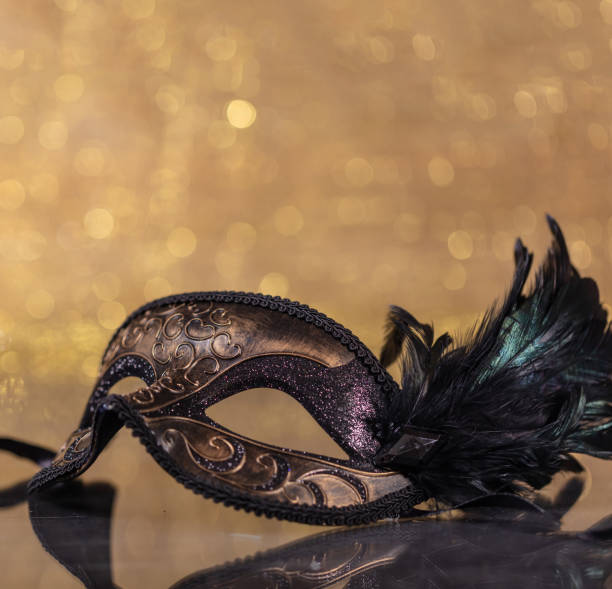 istock Carnival mask with feathers on golden bokeh background. 1294930231