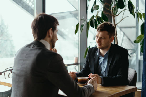 istock Two young businessman having a successful meeting at restaurant. 1294934524