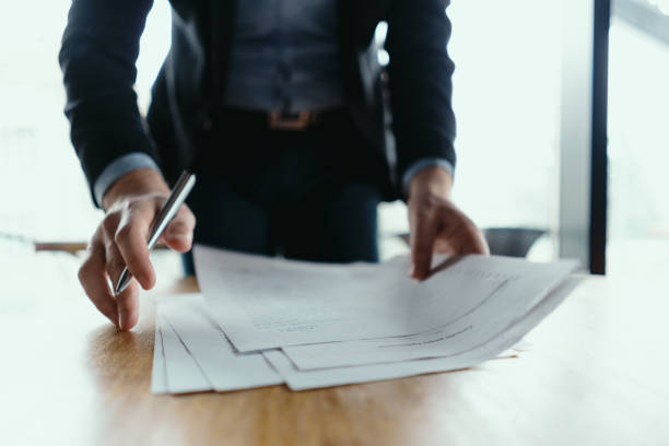 istock Successful business man signing documents in a modern office 1294934696