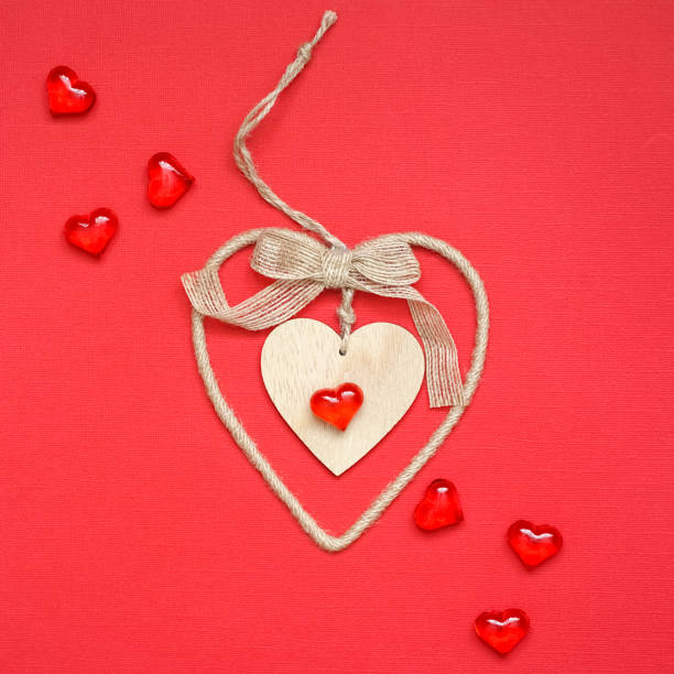 istock Festive composition with wooden heart on red background. Top view, copy space. 1294935539