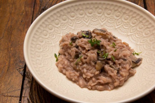 istock Mushroom risotto, on the wooden table. 1294936592
