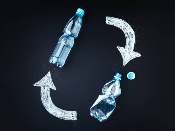 istock Plastic bottle recycling concept. Blackboard, plastic bottles with chalk drawed recycle symbol 1294937713