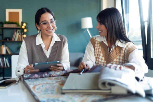 istock Two beautiful designer women working in a design project while choosing materials in the office. 1294938857