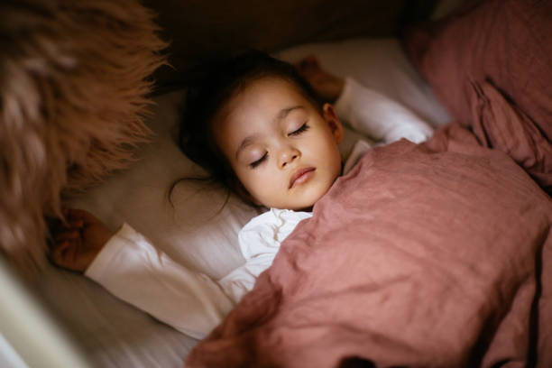istock Little preschool girl sleeping in comfortable bed 1294943310