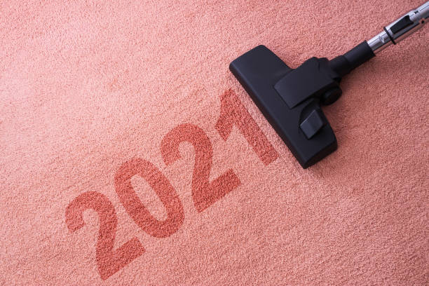 istock 2021 New year home cleaning with vacuum cleaner and copy space for a text 1294944371