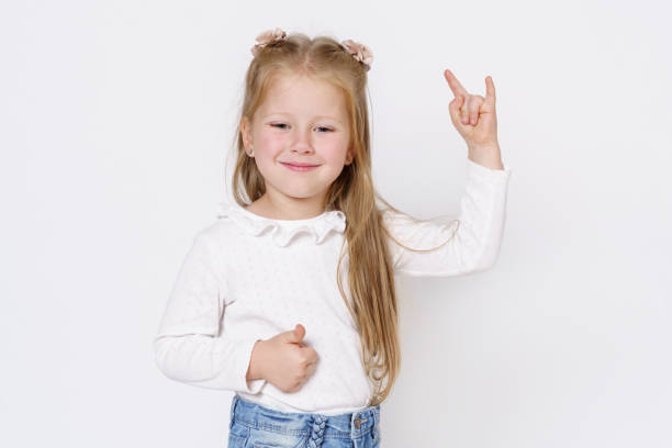 istock The girl shows a hand gesture. Isolated over white background. 1294944522