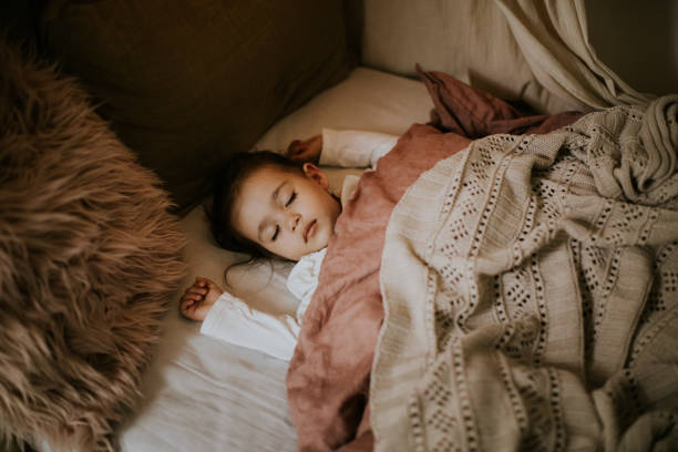istock Little preschool girl sleeping in comfortable bed 1294945087