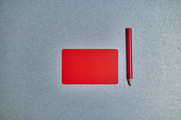 istock Flat lay with red card and red pencil on a gray background. Copy space 1294948657