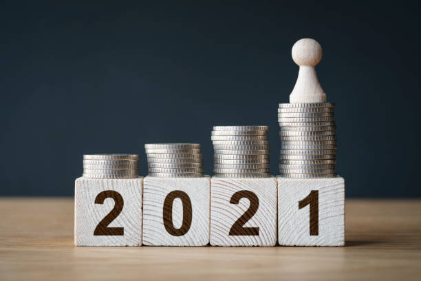 istock Money coins stack stair as step growing growth and wooden cube block 1294949256