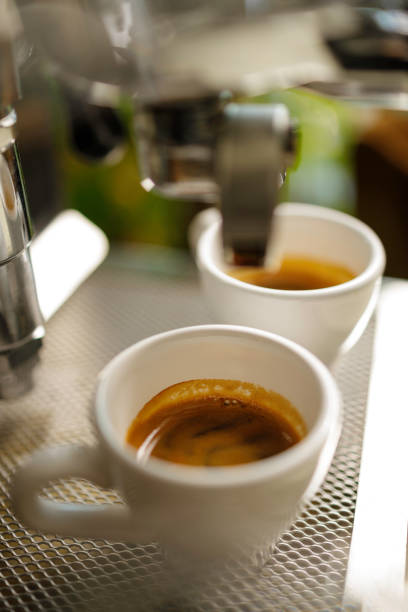istock two cups of espresso being poured from an espresso machine 1294950213