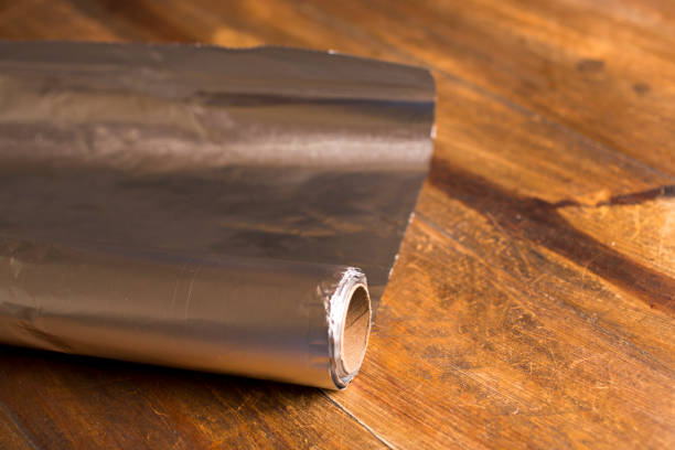istock Shiny Aluminum foil on wooded table. 1294951072