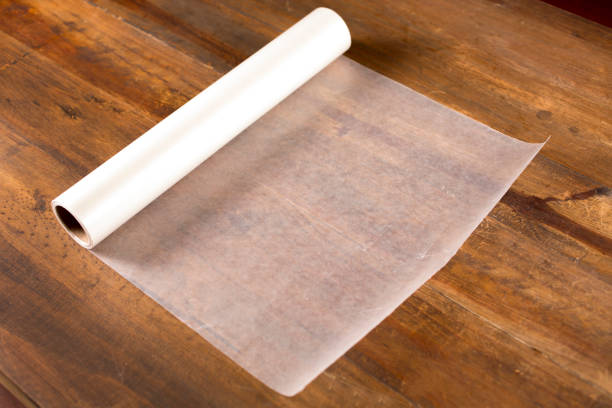 Rolled out Wax Paper on wooden table.