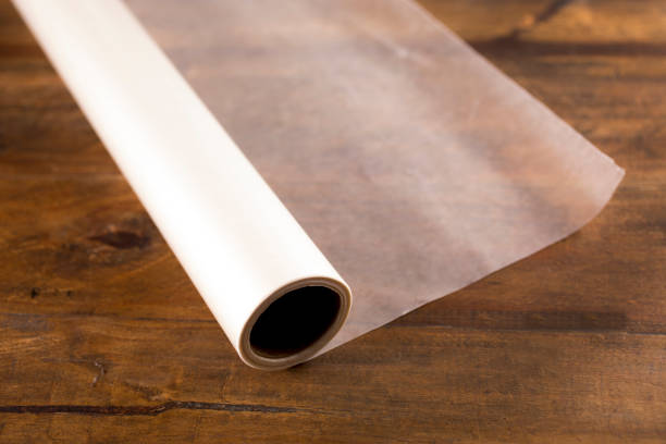 istock Rolled out Wax Paper on wooden table. 1294952351