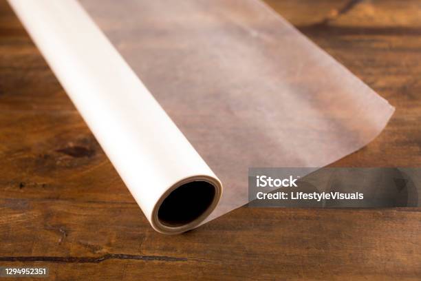 Rolled Out Wax Paper On Wooden Table Stock Photo - Download Image