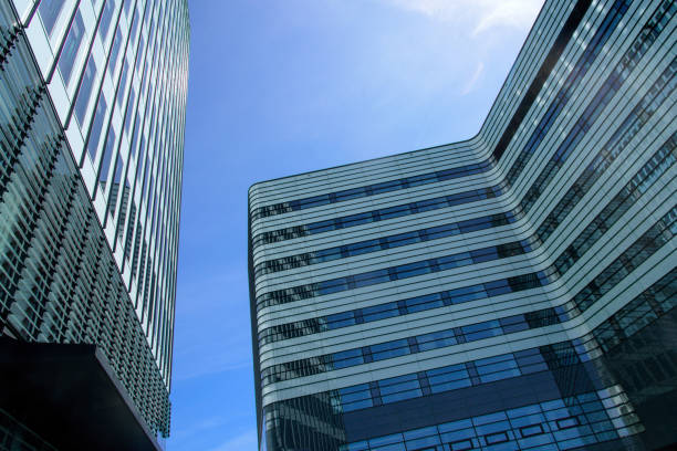 istock modern tall office building on blue sky background 1294953981