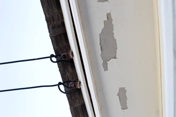 istock White color paint peeling off on ceiling house. Under the roof 1294957744