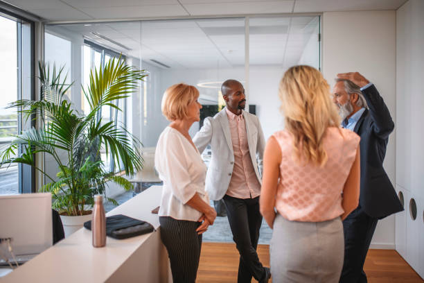 istock Expressive Mature Businessman Describing Idea to Associates 1294958542
