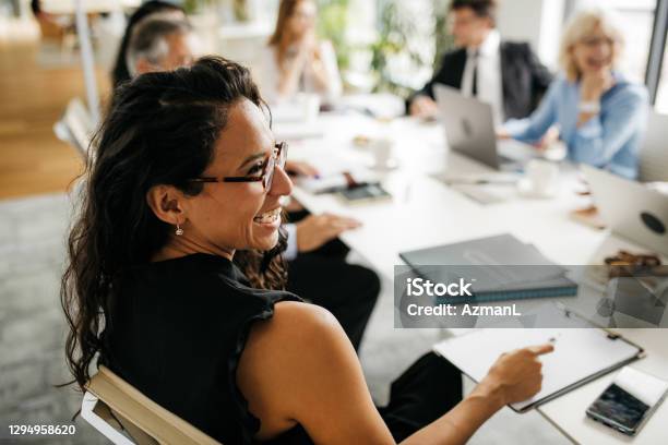 Candid Closeup Of Hispanic Businesswoman In Office Meeting Stock Photo - Download Image Now