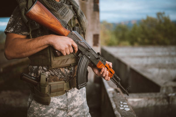 Portrait of Soldier guarded with AK47 on position in abandoned building. Soldier standing in abandoned building with ak47. machine gun stock pictures, royalty-free photos & images